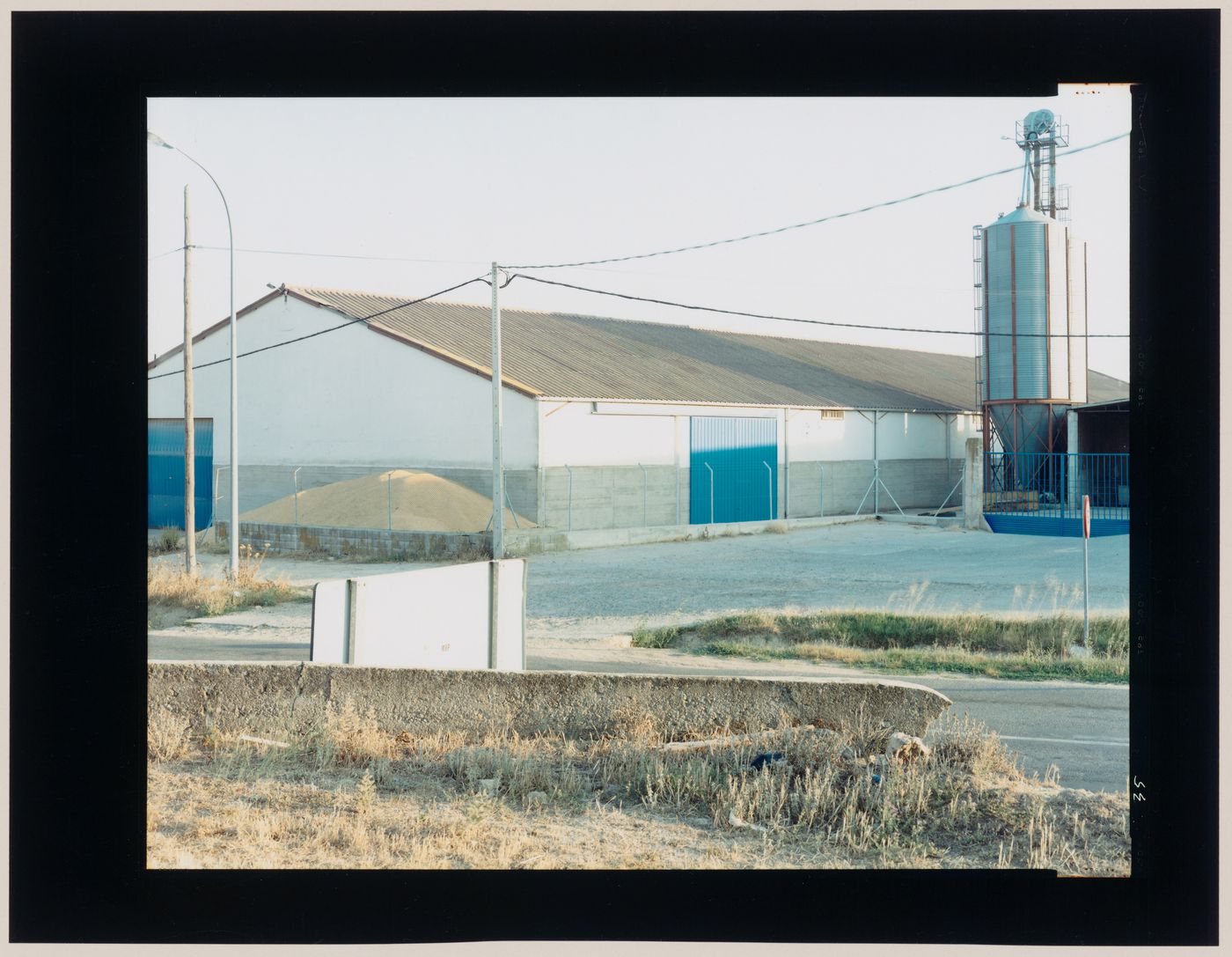 View of an agricultural building and a hopper, Castrojeriz, Burgos Province, Spain (from the series "In between cities")