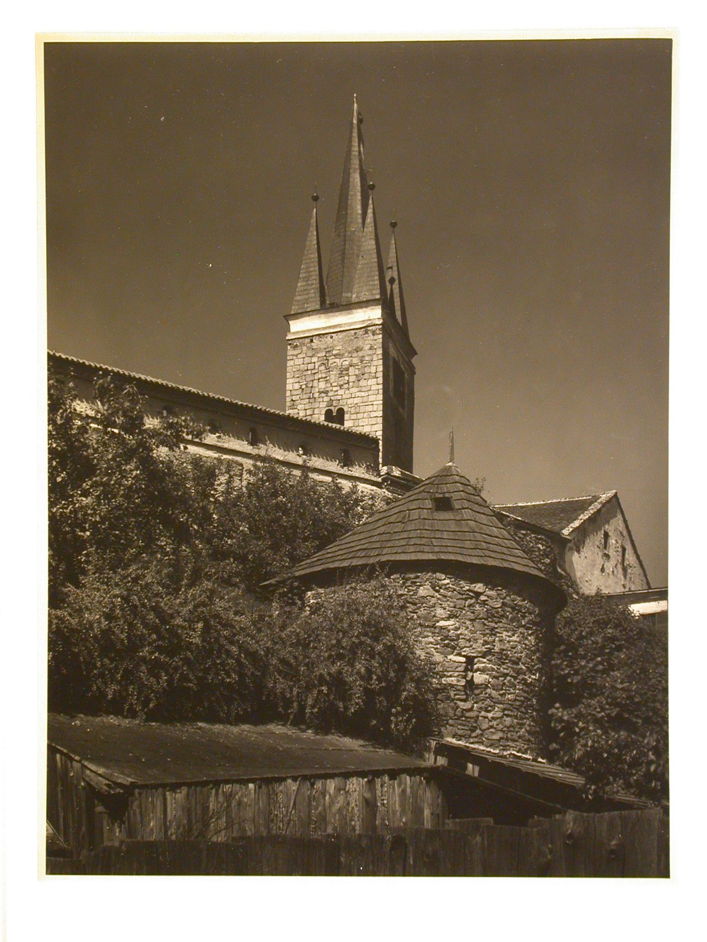 Partial view of the Church of the Holy Spirit showing the tower with the city wall and a fortified tower in the foreground, Telc, Czechoslovakia (now Czech Republic)