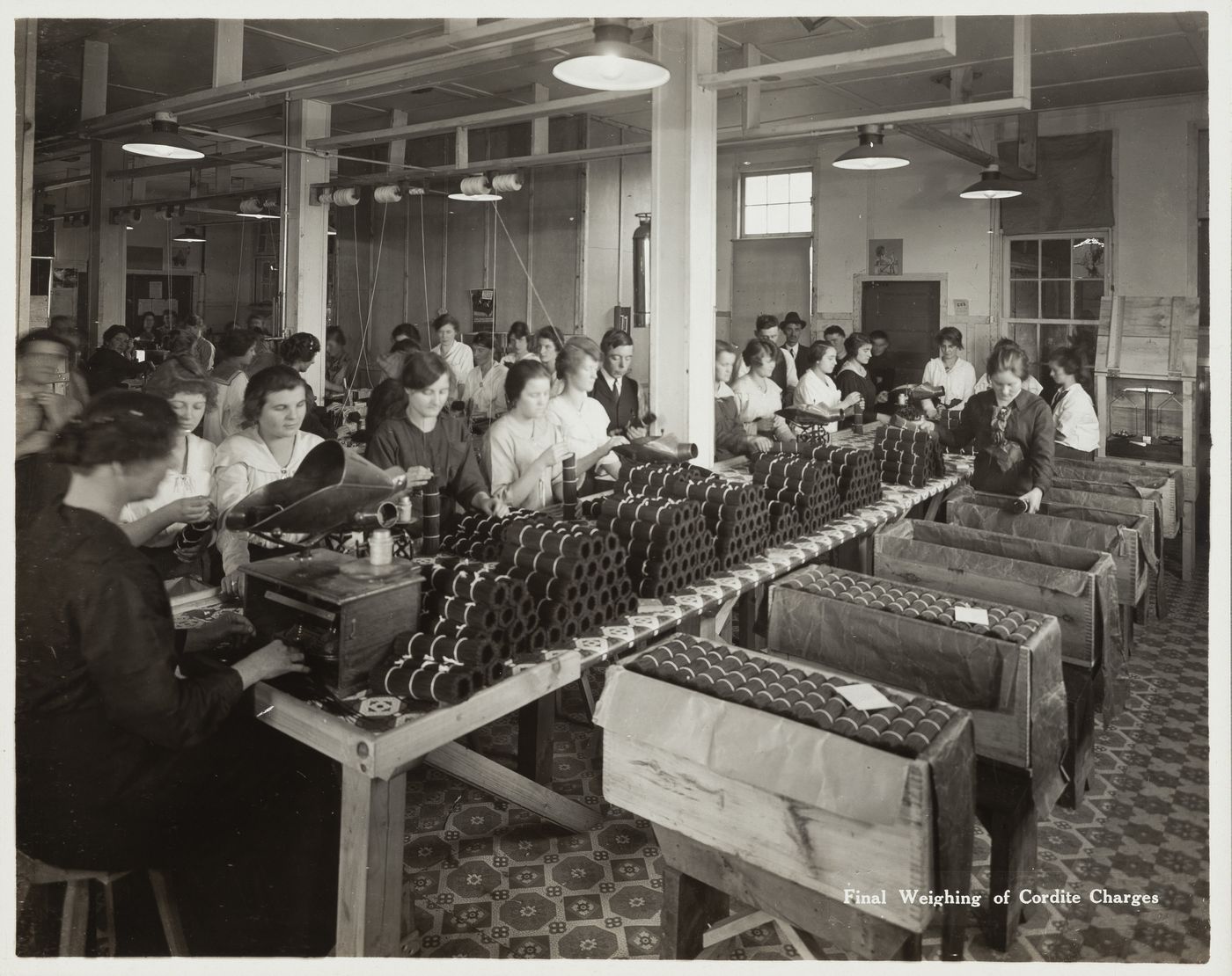 Interior view of workers doing the final weighing of cordite charges at the Energite Explosives Plant No. 3, the Shell Loading Plant, Renfrew, Ontario, Canada