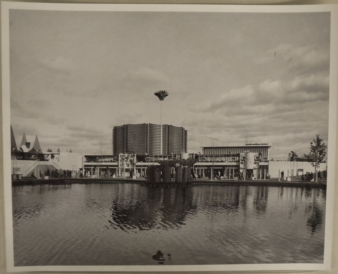 View of a waterway and of the Expo-Service C with the Canadian Pacific-Cominco Pavilion in background, Expo 67, Montréal, Québec