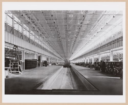 Interior view of the Assembly [?] Building showing cars and a train at the loading dock, Ford Motor Company Automobile Assembly Plant, Richmond, California