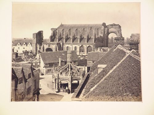 View of a ruined church, surrounding houses in one village, and medieval arched structure, Gloucestershire ?, England