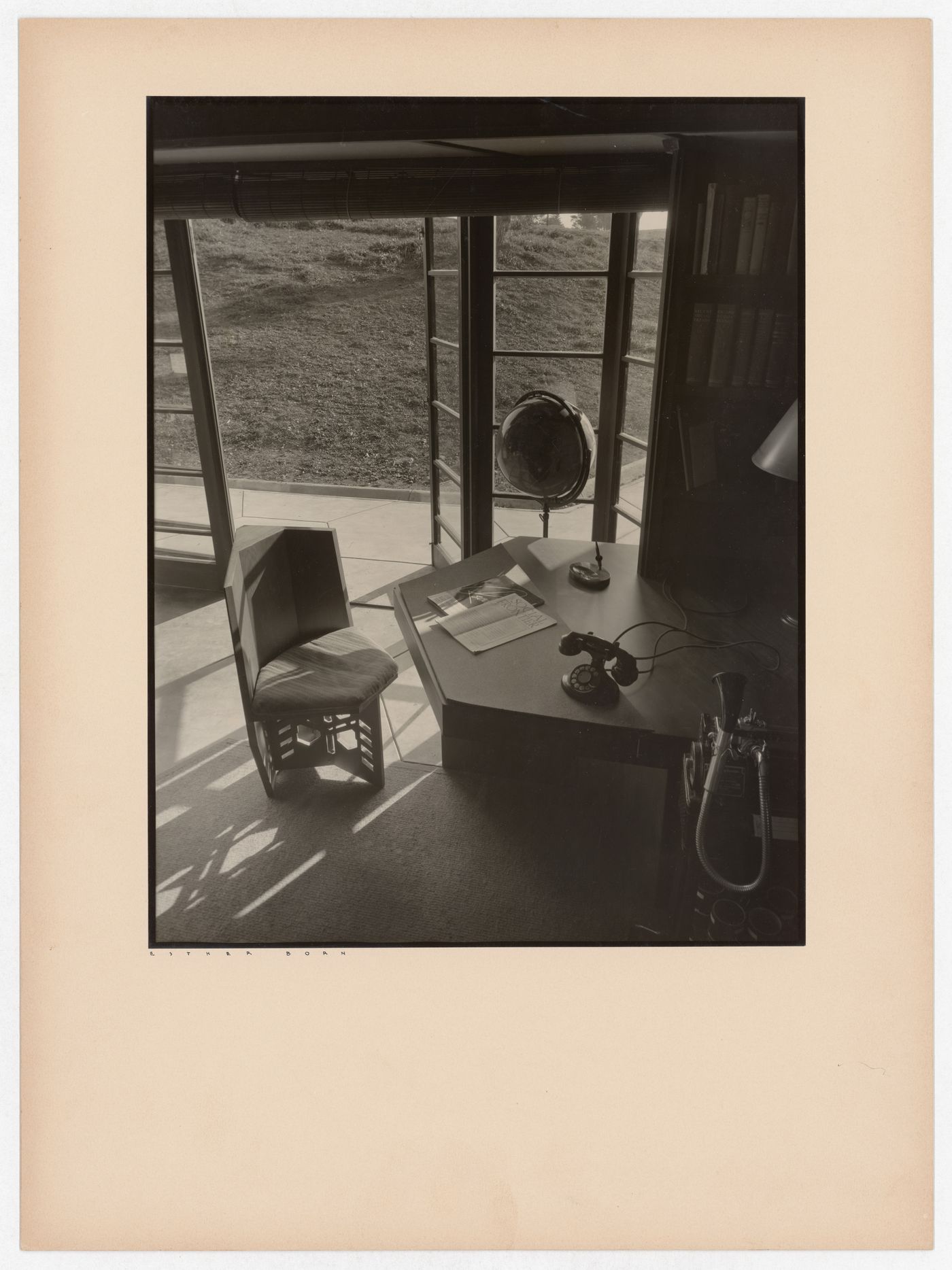 Interior view of the Hanna House showing windows, a doorway, a chair, a desk, a globe, a telephone, a Dictaphone, and two magazines, Palo Alto, California, United States