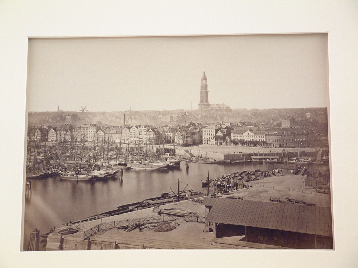 View of harbor, seawall, and Saint Michael's church in distance, Hamburg, Germany