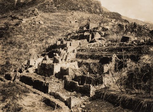 View of Machu Picchu from the Industrial Sector showing the King's Group, Serpent Gate and Torreón in the distance, Peru