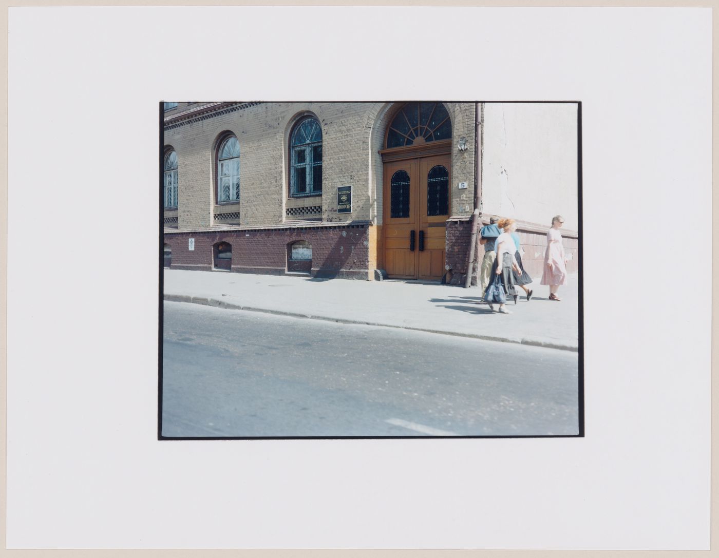 View of a building showing a doorway, a street, and people, Kaliningrad, Kaliningradskaia oblast', Russia (from the series "In between cities")