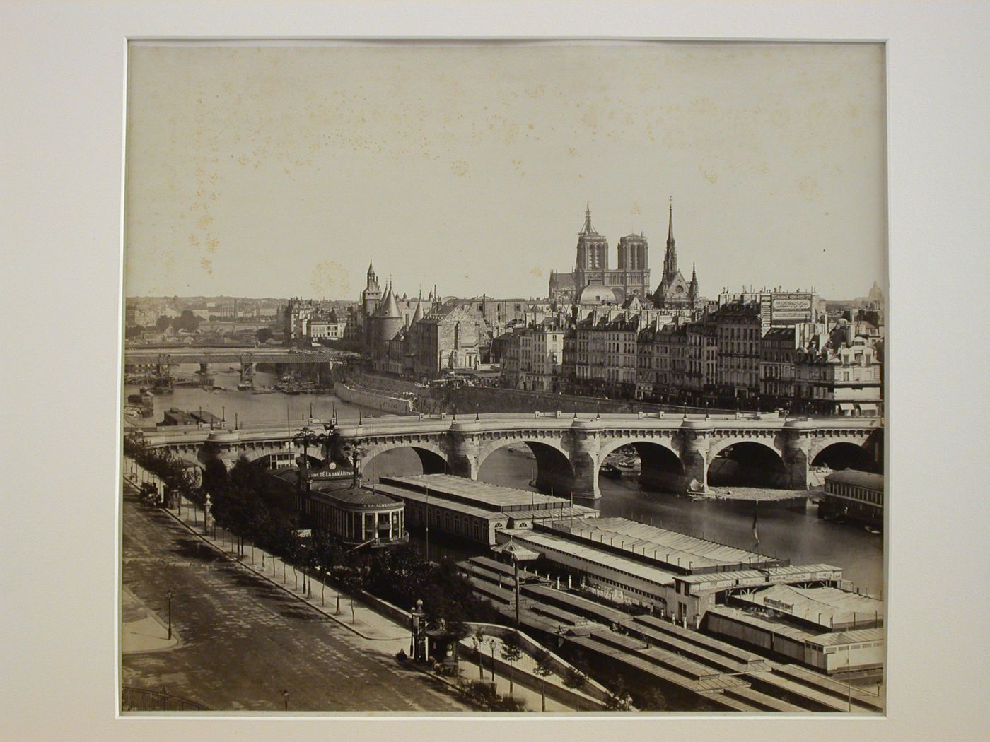 View of the Île de la Cité from the right bank including Richebourg's photographics studio at 29 or 69 quai de l'Horloge, and a partial view of the west façade of Notre-Dame, Paris, France