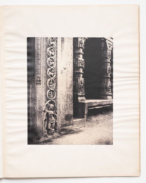 Madura.  Pillars in the recessed portico in the roya gopurum with the base of one of the four sculptured monoliths.