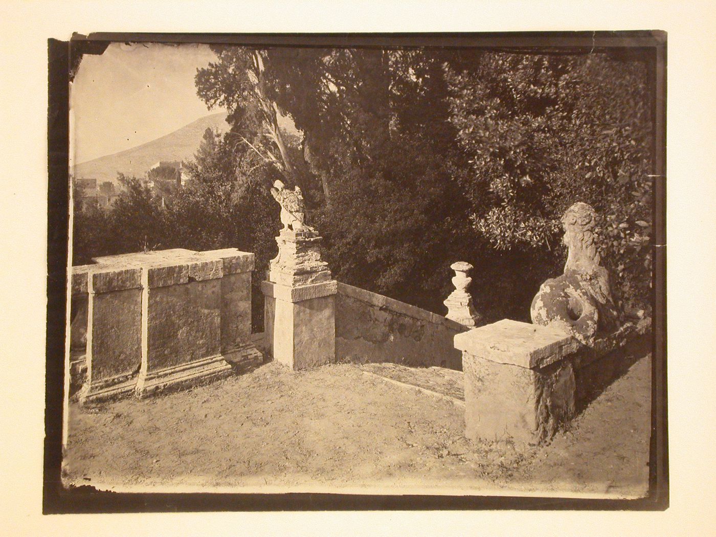 Top of outdoor stairway, with railing, carvings, foliage, Italy