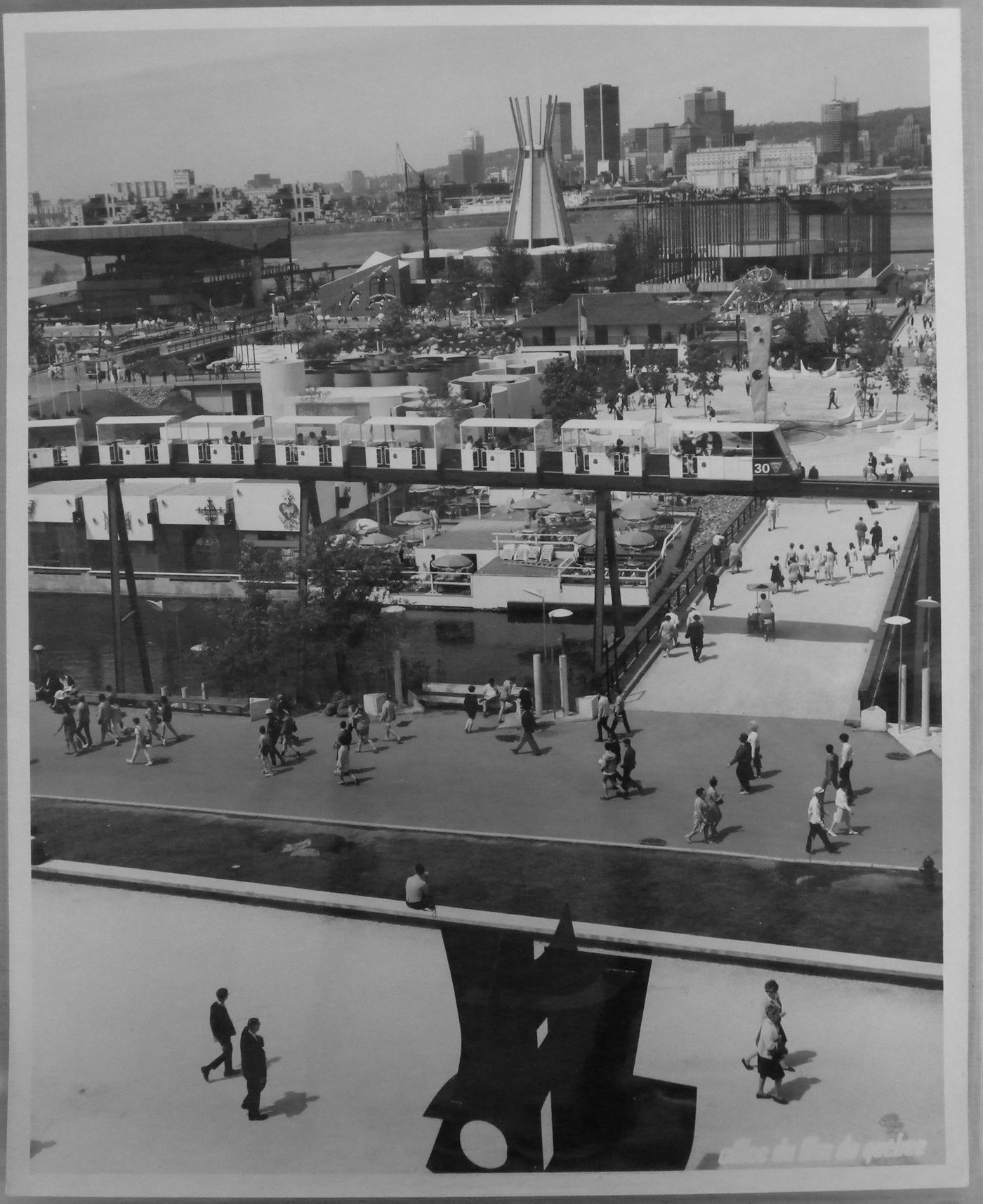 Partial view of the Île Notre-Dame site with a minirail in foreground and Montréal in background, Expo 67, Montréal, Québec