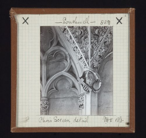 Detail view of top of choir screen with sculpture of man's head, Southwell Minster, Southwell, Nottinghamshire, England