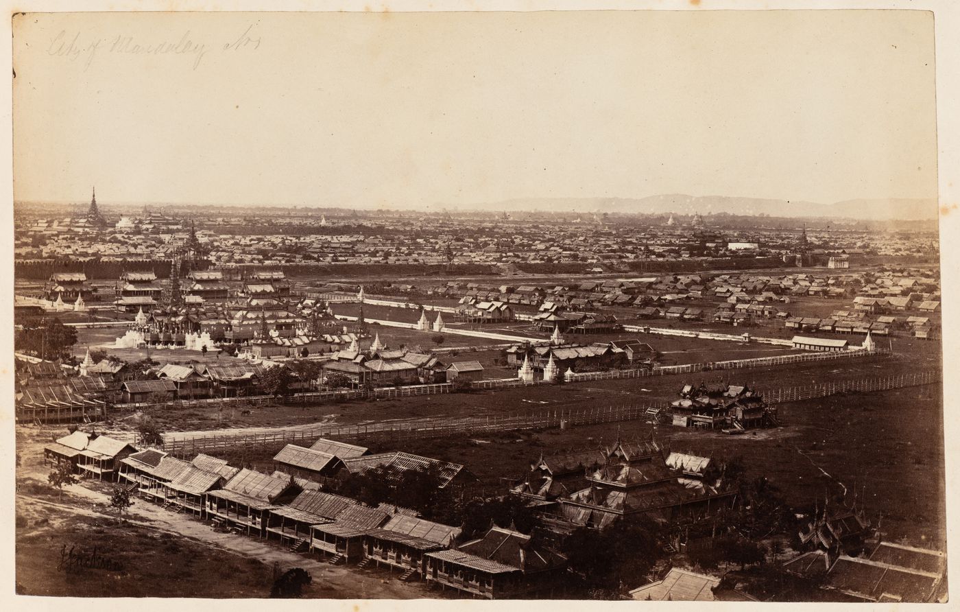 View of Mandalay showing a monastery (now demolished), the city wall, the Royal Palace (now rebuilt) and buildings, from Mandalay Hill, Burma (now Myanmar)