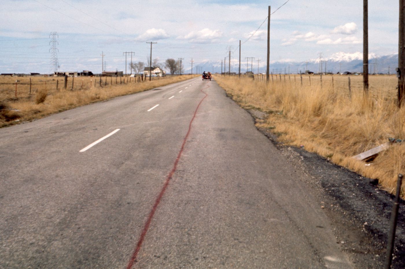 Slide of truck spraying red paint on road for Red Line
