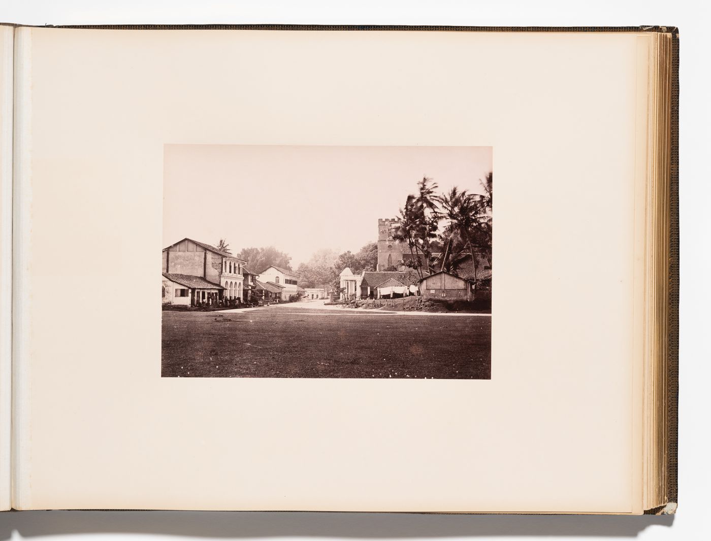 View of a street, unidentified buildings and St. Paul's Church, Kandy, Ceylon (now Sri Lanka)
