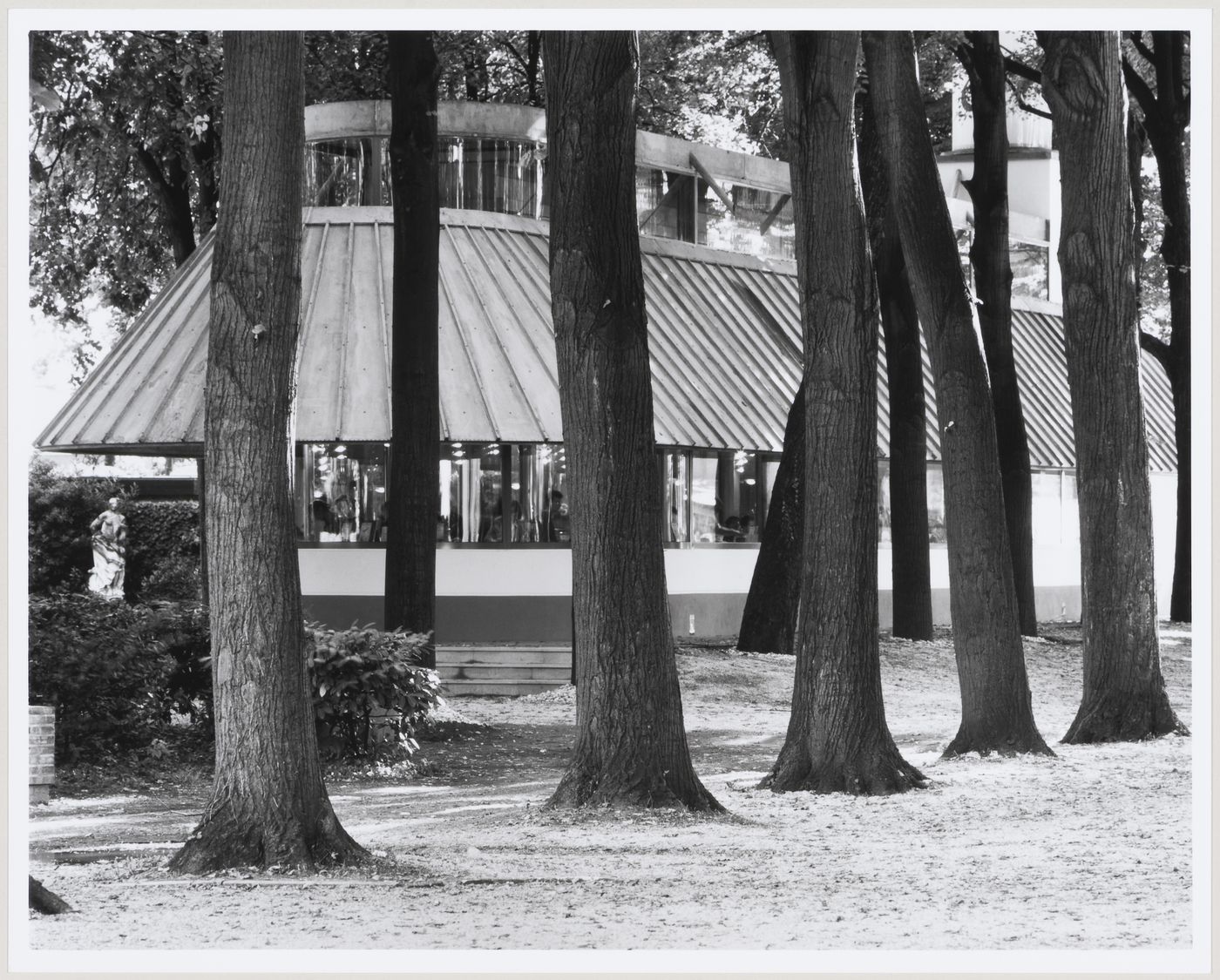 Biennale bookshop, Venice, Italy: view with a tree-lined path in the foreground