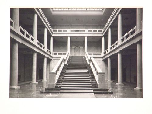 Interior of large building, two-story courtyard with skylight and large staircase, Munich, Germany