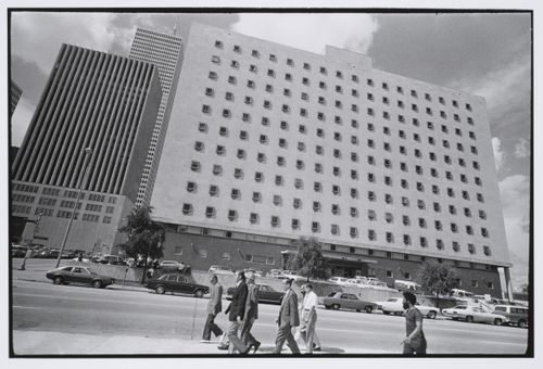 Street scene, white building with dark windows