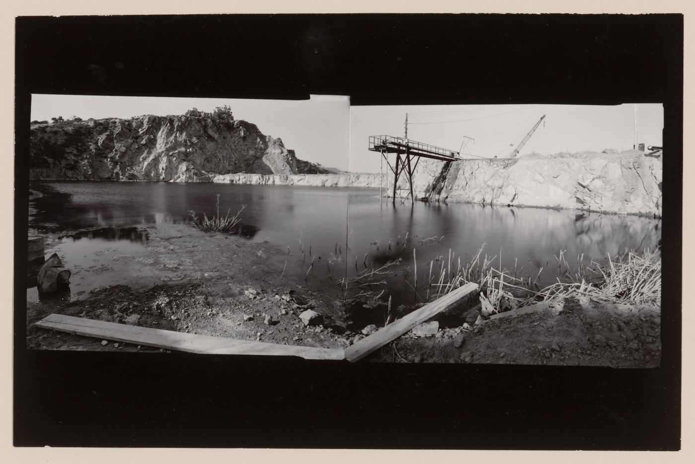 Panoramic composite photograph of the San Rafael Rock Quarry showing a lake, cliff and machinery, Point San Pedro, San Rafael, Marin County, California, United States