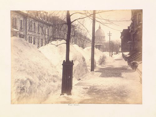 View of rue Peel after a heavy snowfall with the dome of the Cathédrale Saint-Jacques-le-Majeur (now the Cathédrale Marie-Reine-du-Monde) in the background, Montréal, Québec