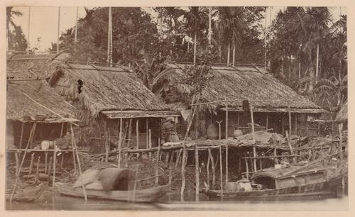 View of houses beside a river, probably in Cochin China (now in Vietnam)