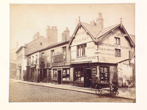 View of shops in Long Millgate, including Moore's Railway Refreshment Rooms, Manchester, England