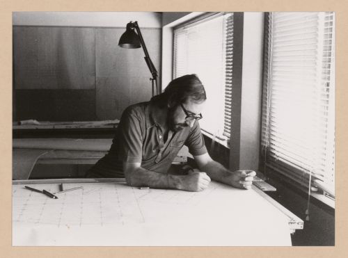 Portrait of Álvaro Siza at drafting table possibly showing design process for Edifício de Escritórios na Av. D. Afonso Henriques, Avenida da Ponte, Porto, Portugal