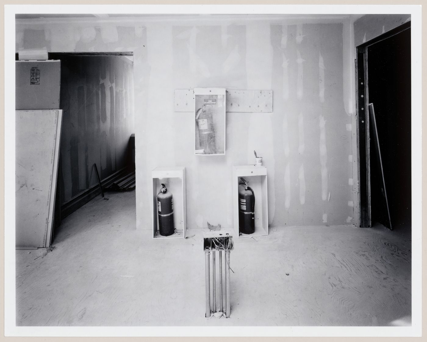 Interior view showing fire extinguishers temporarily installed on a wall, Shaughnessy House under renovation, Montréal, Québec