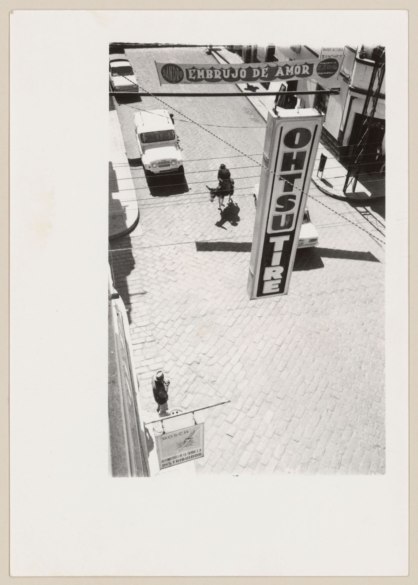 Street scene with sign and donkey, South America