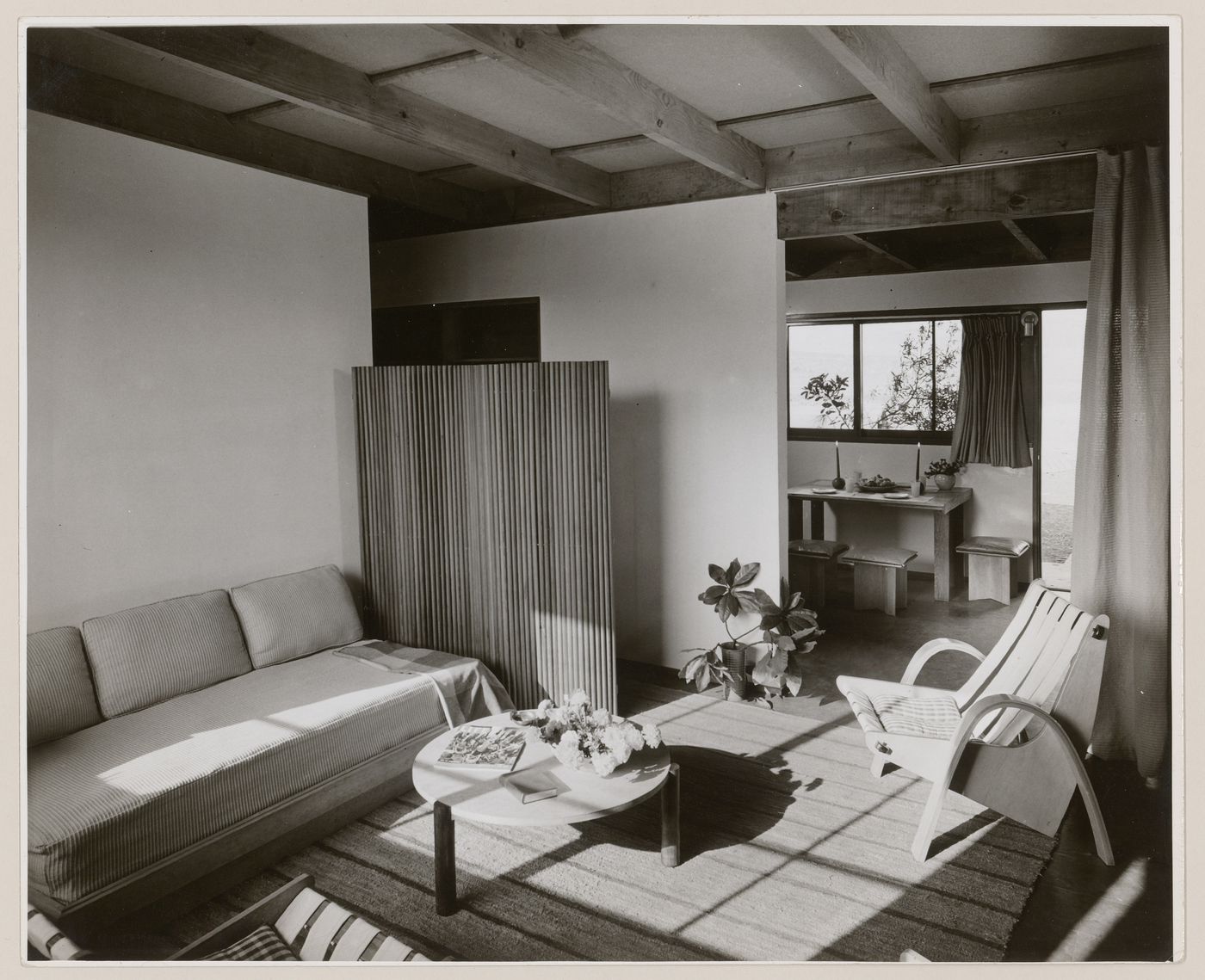 Interior view of furnished living and dining rooms in a one storey duplex