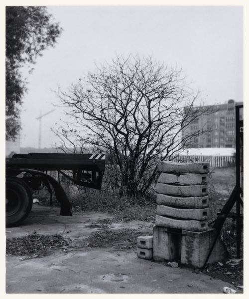 View of building materials, trees and the back of a truck showing a building in the background, Berlin, Germany, from the artist book "The Potsdamer Project"