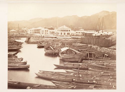 View of buildings, boats and a bridge in the foreign settlement, Kobe, Japan