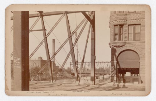 Partial view of Union Avenue Bridge (now demolished) and Arkansas River, with electric streetcar powerhouse in the left background, Pueblo, Colorado, United States
