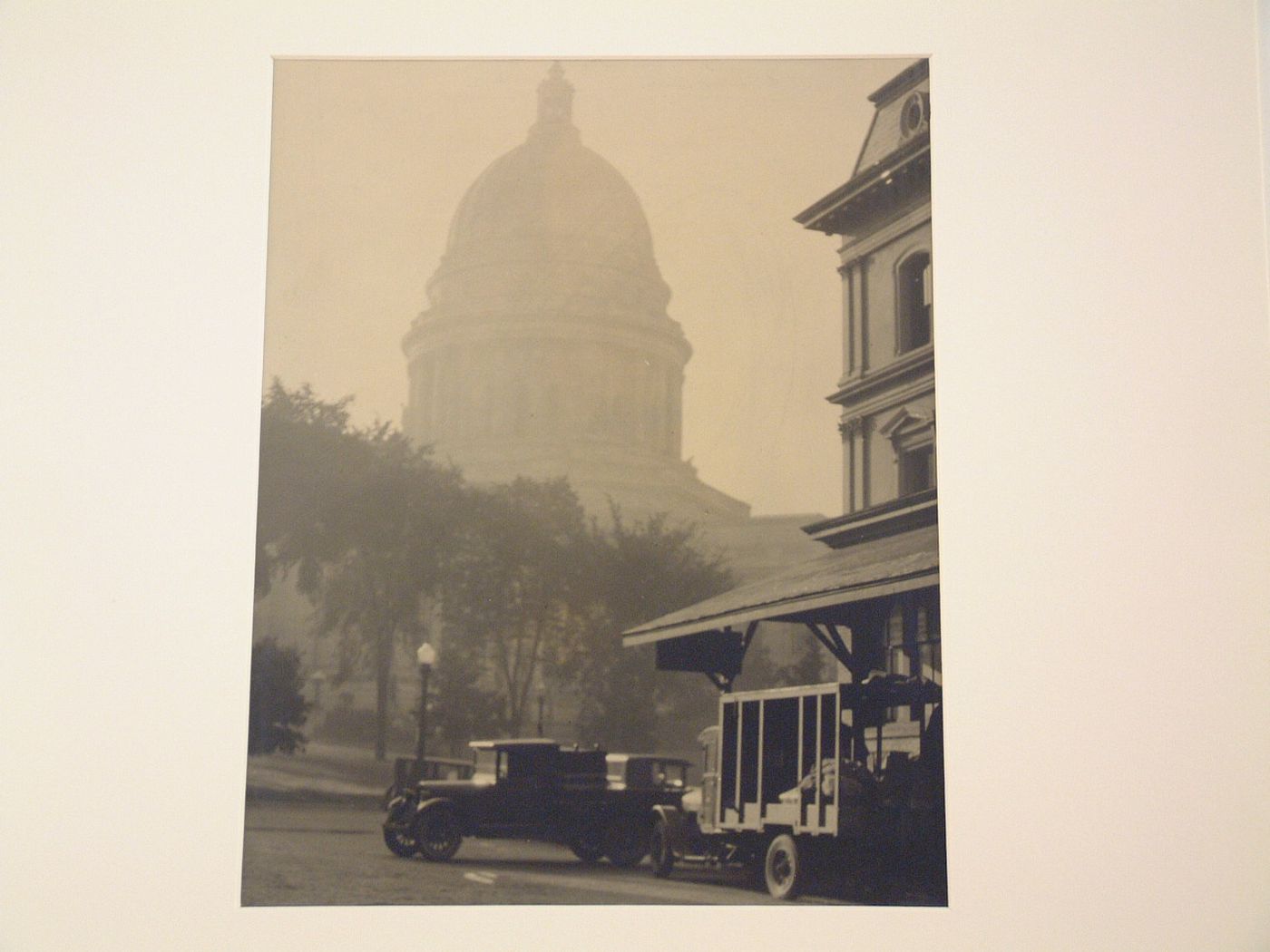 Capitol dome in distance, cars and house, right foreground, Madison, Wisconsin