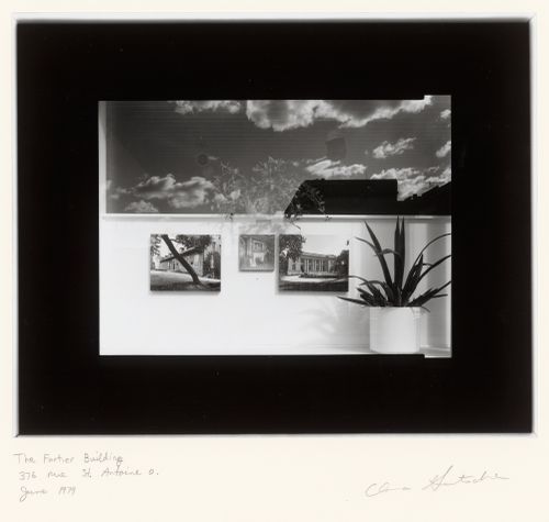View of a window of the Fortier Building, 376 rue Saint-Antoine Ouest, Montréal, Québec, showing a display of photographs of the Château de Ramezay and the Château Dufresne