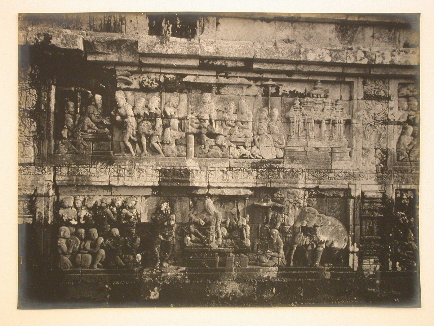 Close-up view of relief panels on the temple of Borobudur depicting an elephant, horses and figures, Borobudur, Indonesia