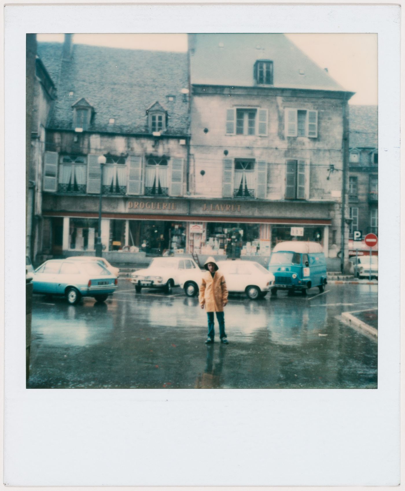 Buildings and parking lot with young boy, Dole, France
