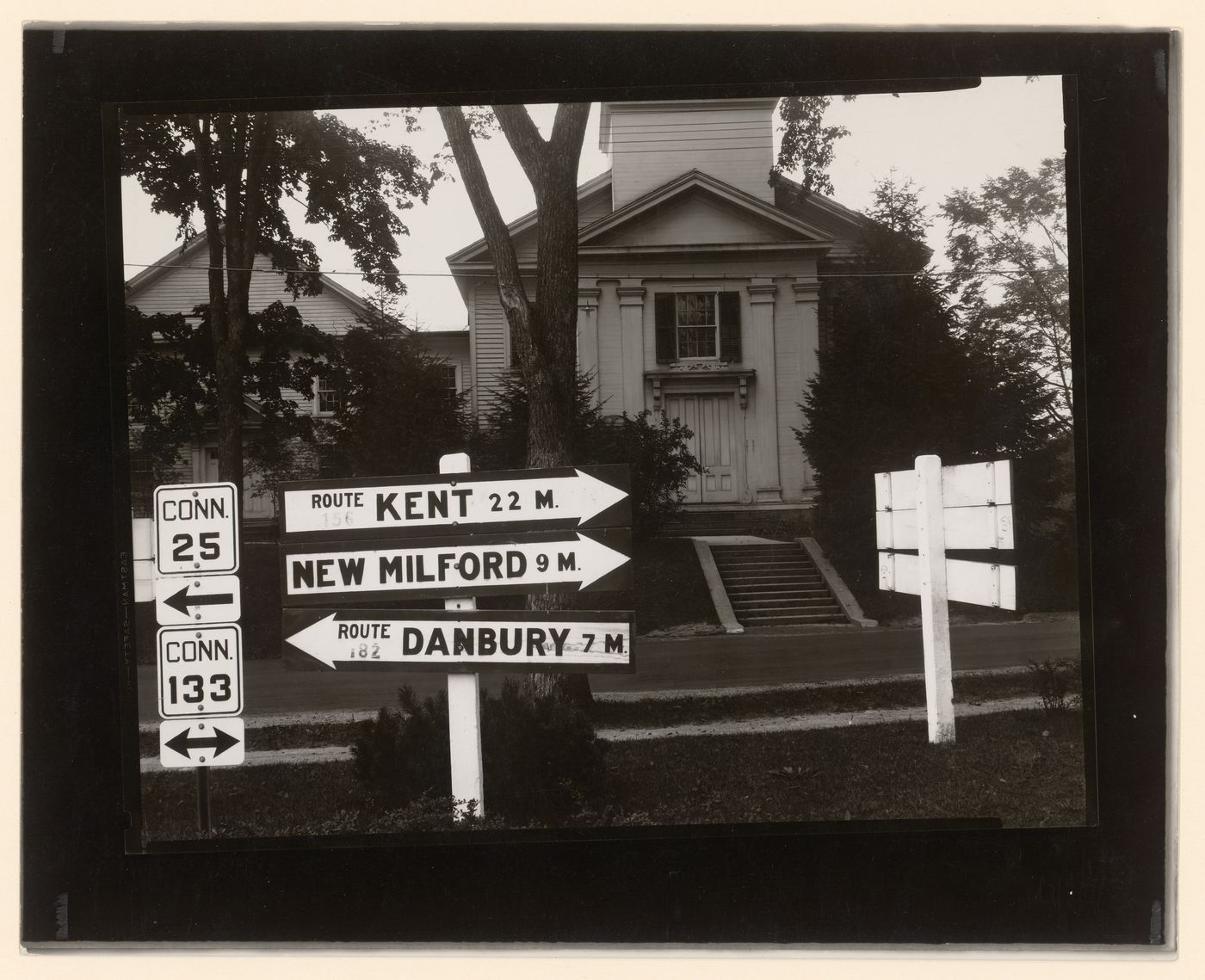 Connecticut Road signs: Arrow-shaped signs with towns, mileage and route numbers in front of a wooden church