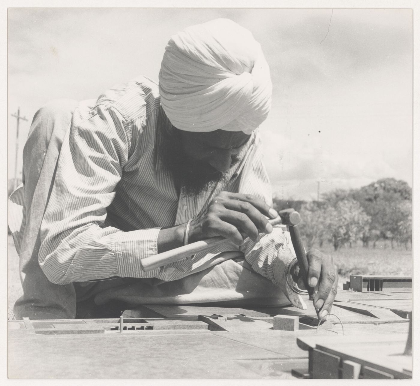 Portrait of the model maker, Rattan Singh, at work on the model for Capitol Complex, Sector 1, Chandigarh, India