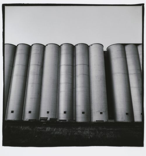 Wide-angle view of tall, tube-shaped grain elevators, Minneapolis, Minnesota