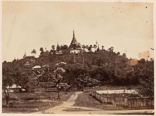 Distant view of a stupa, possibly known as Moulmein Pagoda, on a hill showing other buildings, Moulmein, Burma (now Myanmar)