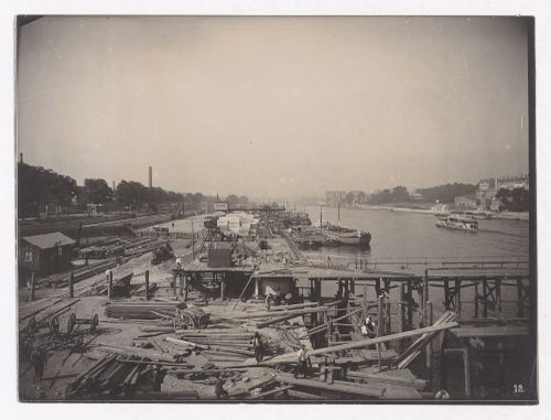Construction of the Paris Metro, exterior view of construction site near the Seine and boats, Paris, France