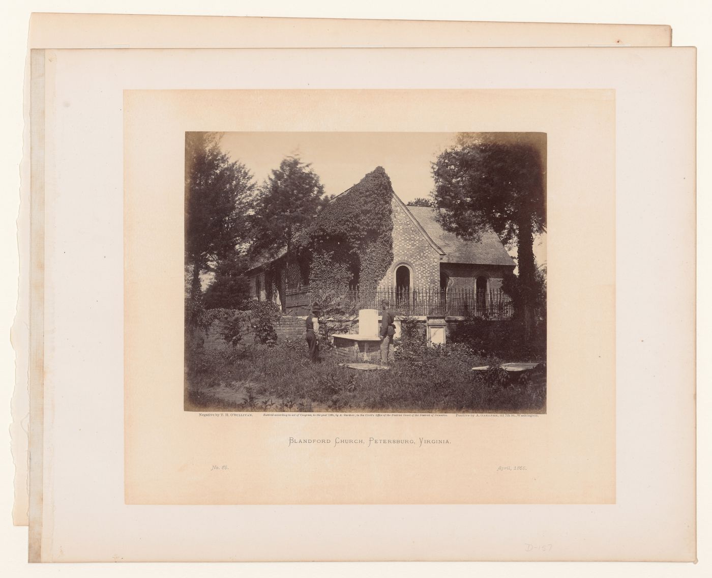 Rear view of Blandford Church (now Old Blandford Church of Bristol Parish) with a soldier and a man in the cemetery, Petersburg, Virginia, United States