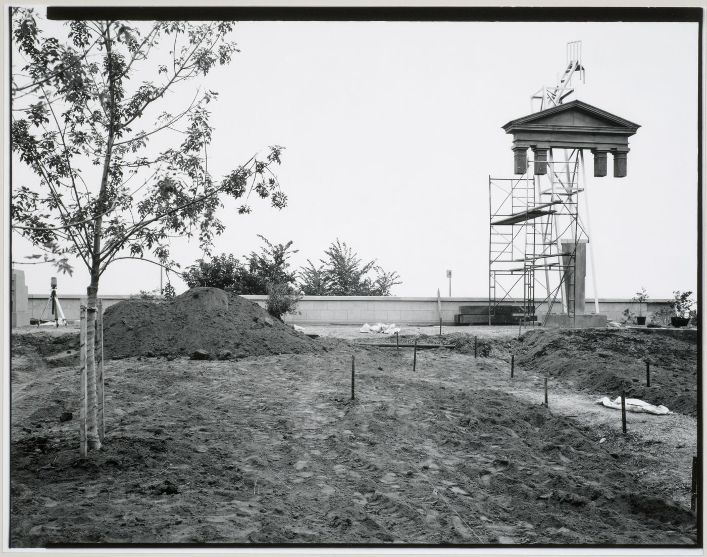 View of the Canadian Centre for Architecture Garden under construction showing the Tribune Allegorical Column surrounded by  scaffolds, Montréal, Québec, Canada