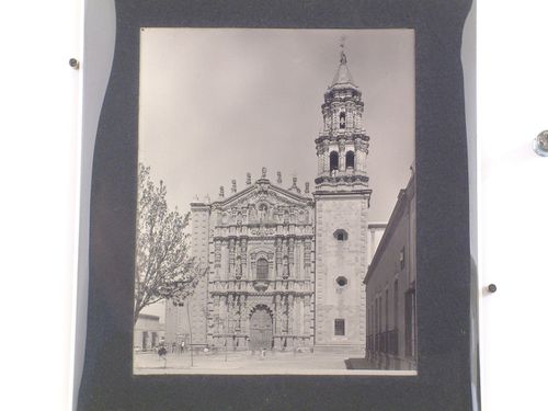 View of the principal façade of the Church of the monastery of Carmen de San Luis Potosí showing a square and people in the foreground, San Luis Potosí, Mexico