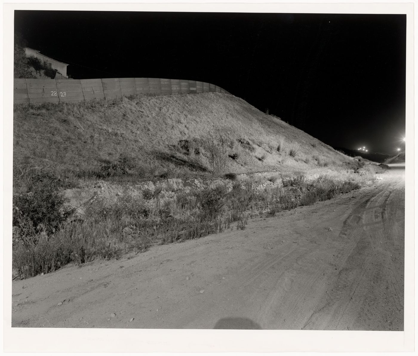 Partial night view of the United States-Mexico border fence from the United States side, San Diego County, California, United States, and Tijuana, Baja California, Mexico