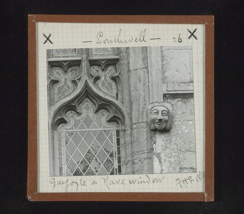 View of sculpture of head and partial view of stained glass window of nave, Southwell Minster, Southwell, Nottinghamshire, England