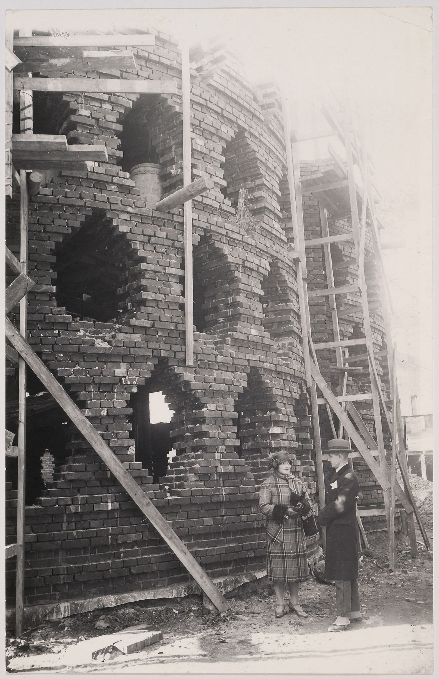 View of the Melnikov residence under construction showing Melnikov and his wife, Moscow