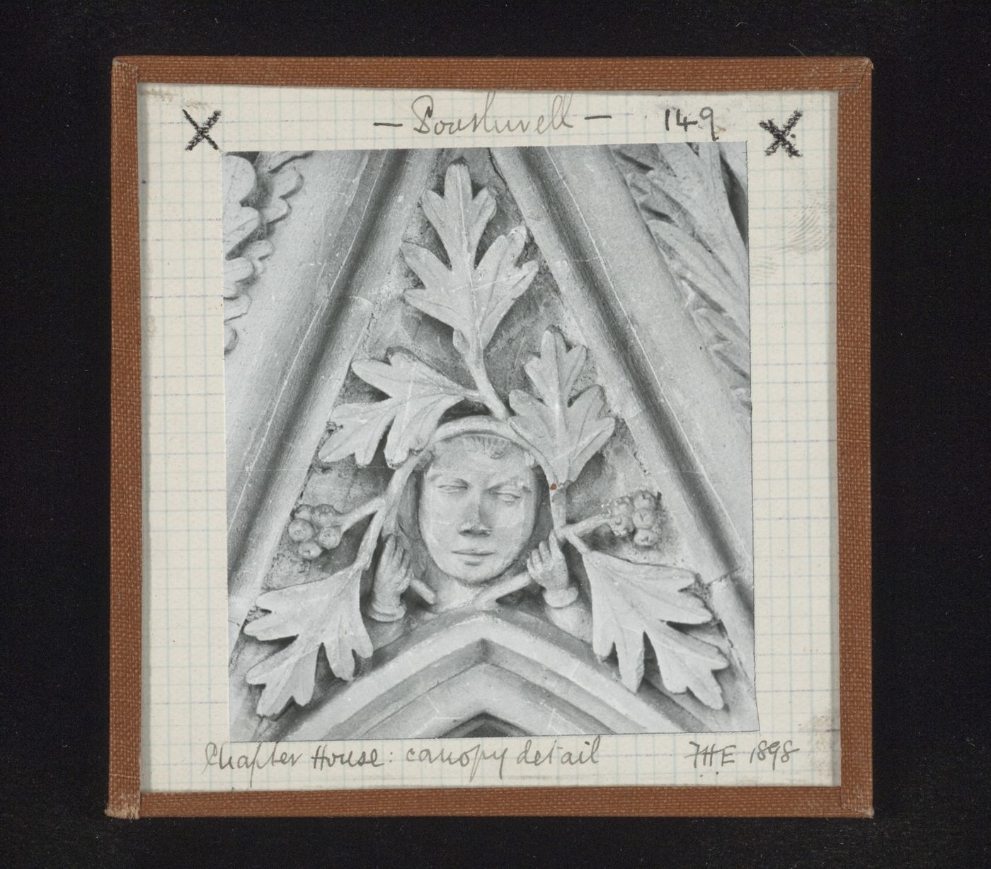 Detail view of canopy with foliate mask on tympanum in Chapter House, Southwell Minster, Southwell, Nottinghamshire, England