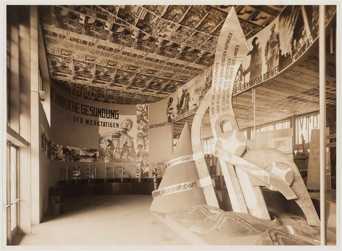 Interior view of the Soviet Union installation designed by El Lissitzky showing murals and sculpture, Dresden Hygiene Exhibition, Germany