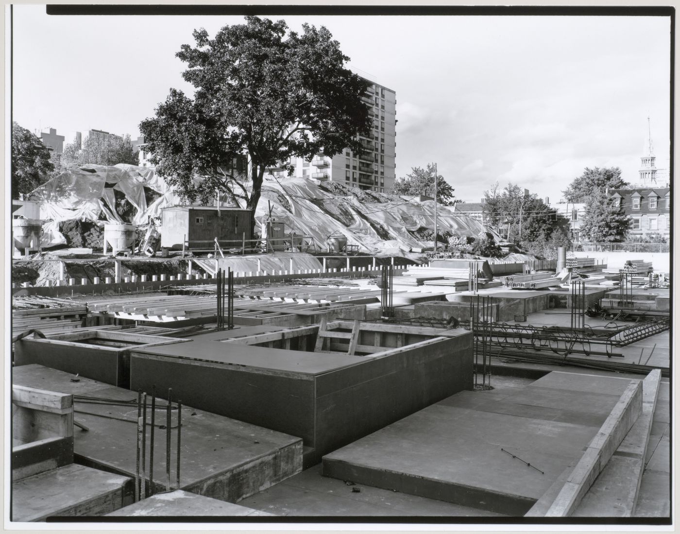 View of the construction site from the west with an apartment house and a construction workers' trailer in the background, Canadian Centre for Architecture under construction, Montréal, Québec